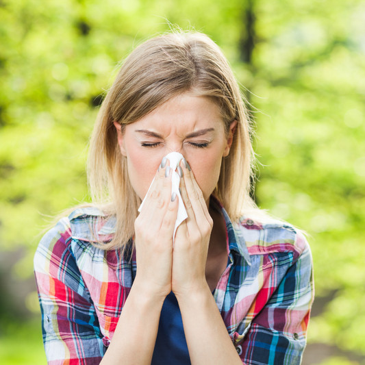image of lady with a tissue after sneezing blog article on spring seasonal changes