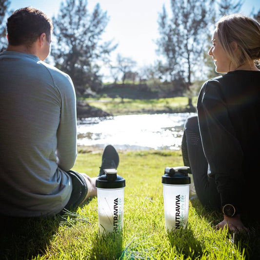 couple having collagen drink in park