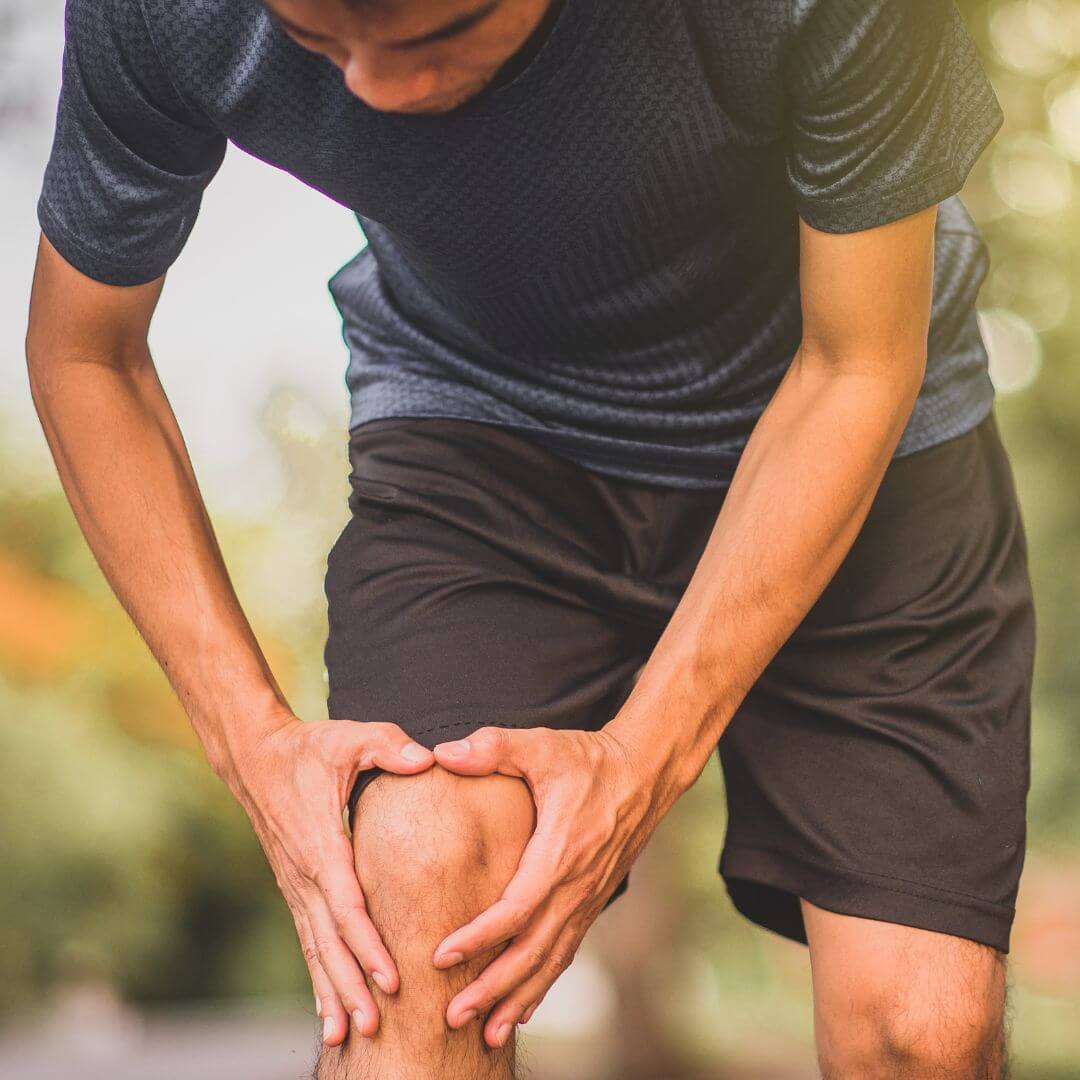 collagen supplement blog image shows man holding knee 