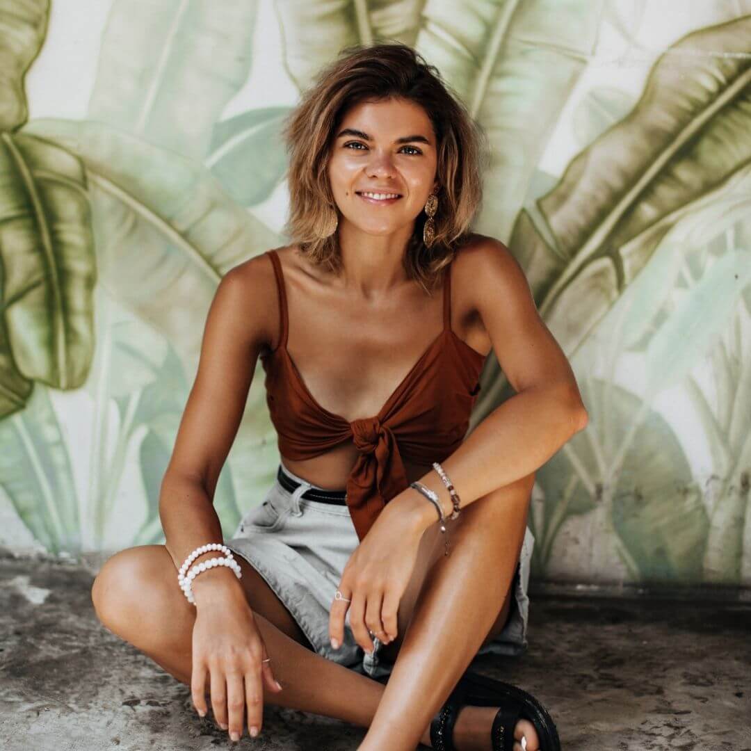 natural beauty tanned woman with mural backdrop 