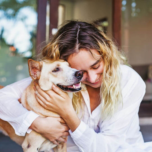 woman hugging dog