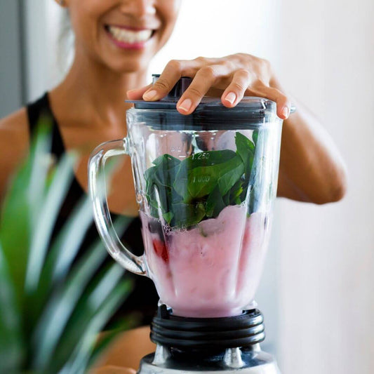 woman making collagen fruit smoothie