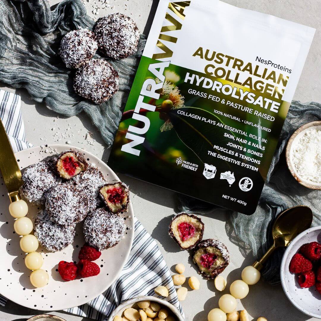 collagen lamington power balls arranged on a table with macadamias and raspberries with a pack of Australian Collagen powder