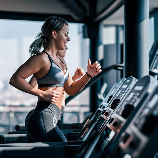 woman running on treadmill at gym