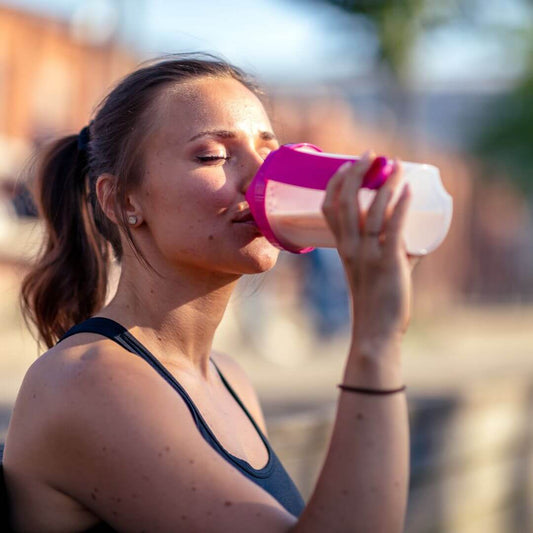women drinking a workout protein shake