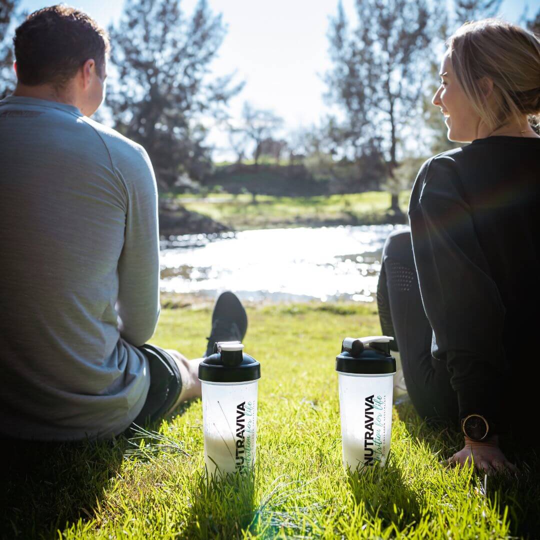 couple at river drinking collagen shake