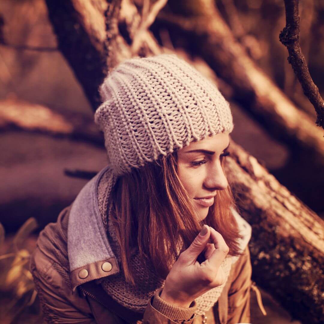 woman in warm coat and beanie outside in winter