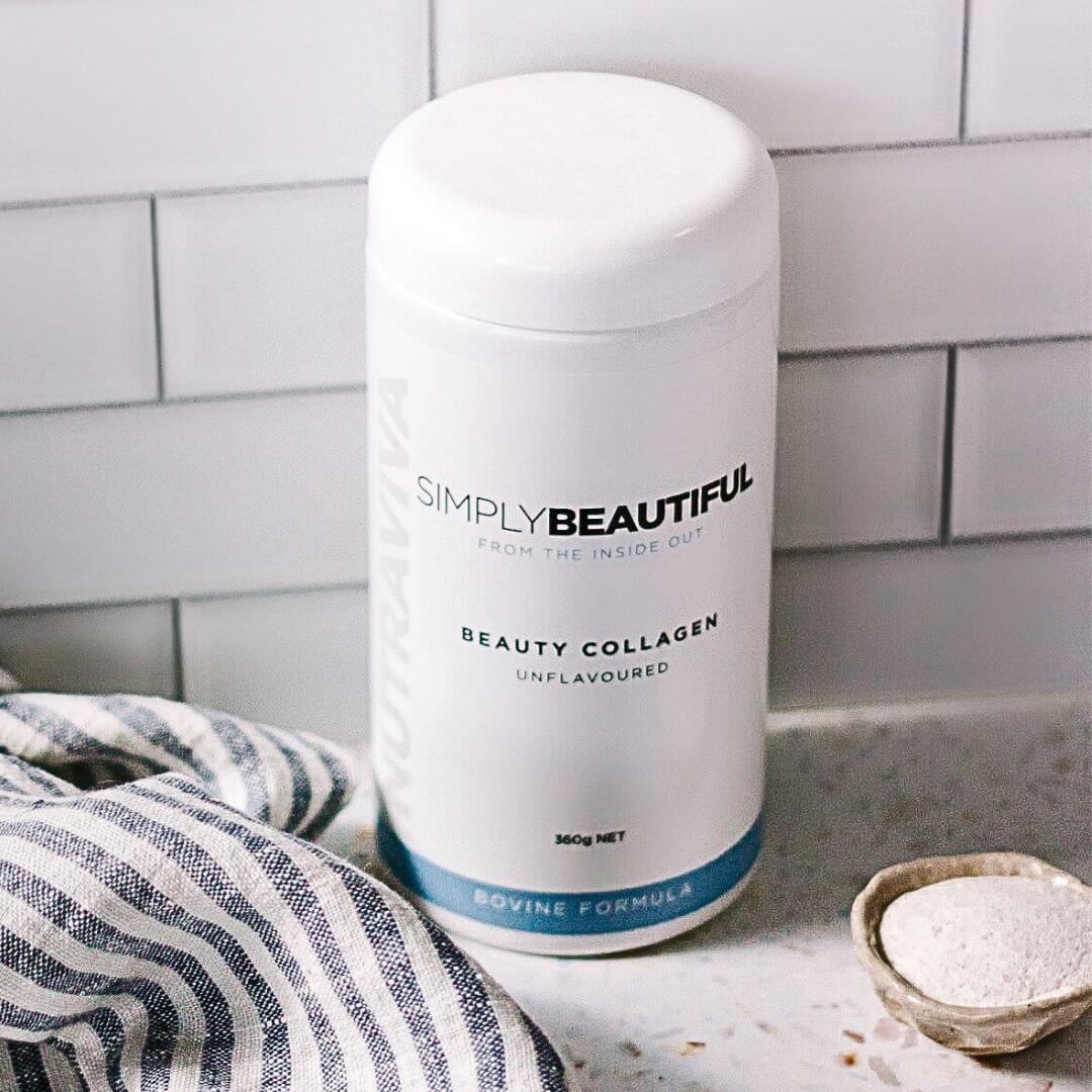 image of Nutraviva Simply Beautiful beauty collagen powder sitting on bench with collagen powder in a bowl to the right hand side